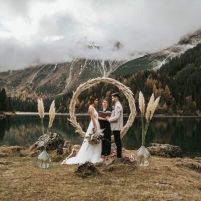 The ultimate elopement guide; Bride and groom holding hands and staring at each other during their elopement ceremony