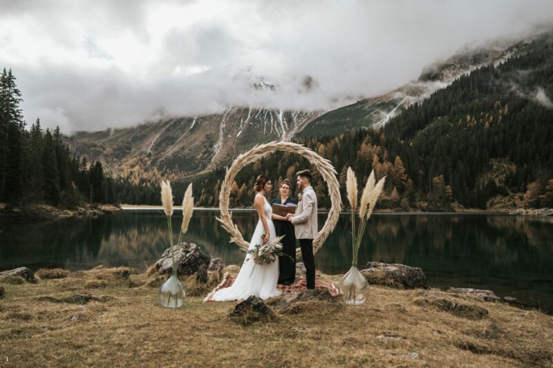 The ultimate elopement guide; Bride and groom holding hands and staring at each other during their elopement ceremony